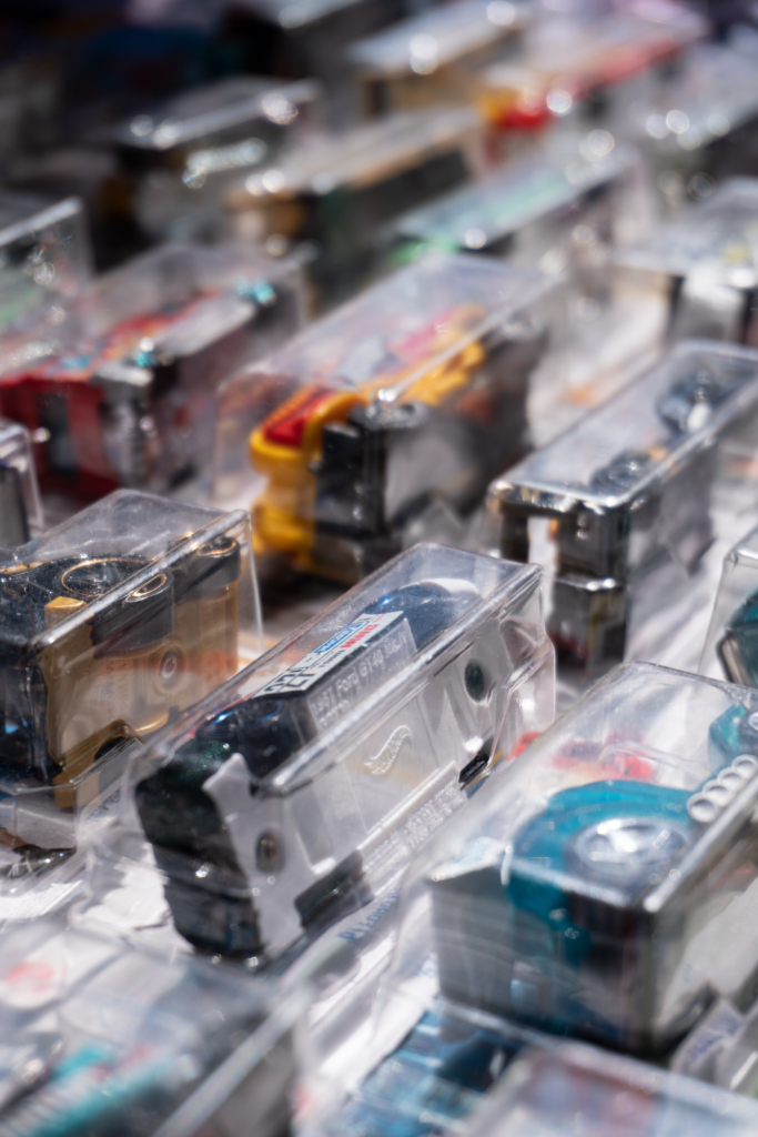 Vibrant toy cars displayed in packaging at a Guadalajara market, showcasing colorful details.