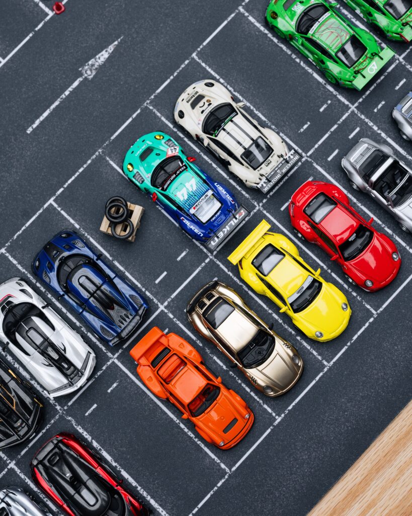 Overhead view of vibrant diecast cars arranged in a mini parking lot setting.