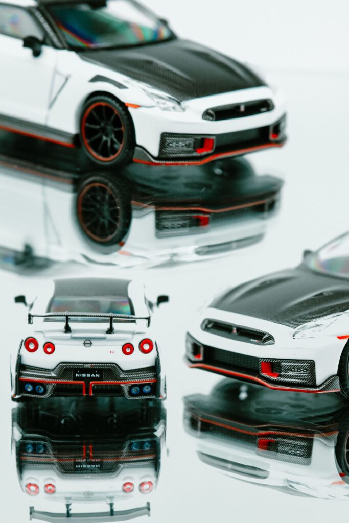 Close-up of sleek model cars showcasing intricate details and reflections.