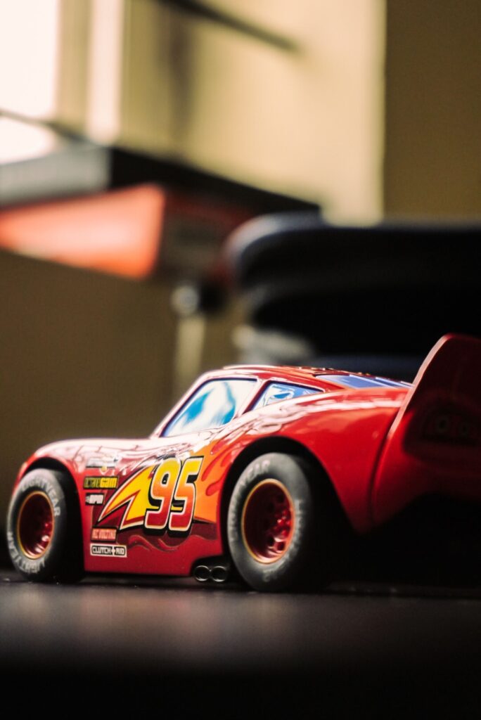 Detailed shot of a red toy car with vibrant colors indoors.